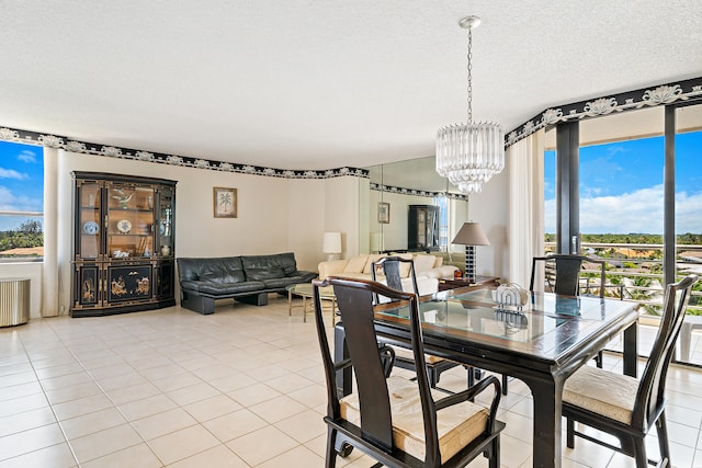 tiled dining room featuring a textured ceiling, radiator, and a chandelier