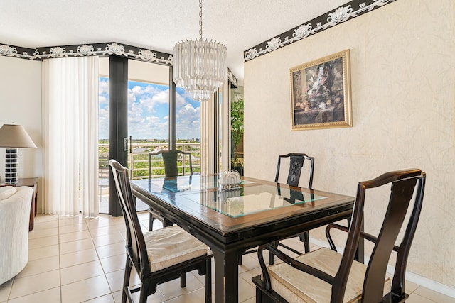 dining area with a textured ceiling, a notable chandelier, and light tile floors