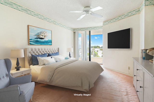 bedroom with access to exterior, ceiling fan, and a textured ceiling