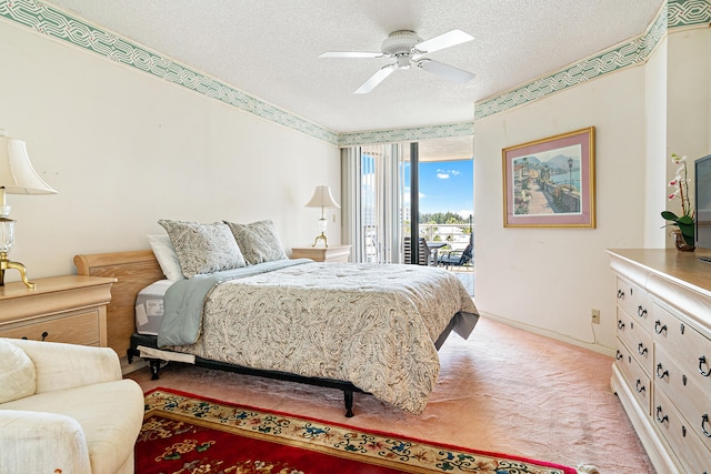 carpeted bedroom featuring a textured ceiling, ceiling fan, and access to outside