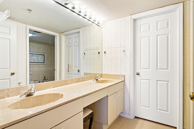 bathroom with dual sinks, oversized vanity, and tile flooring