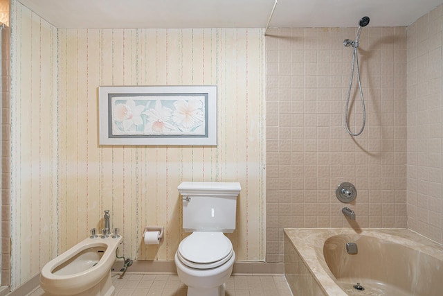 bathroom with a bidet, tiled shower / bath, toilet, and tile flooring