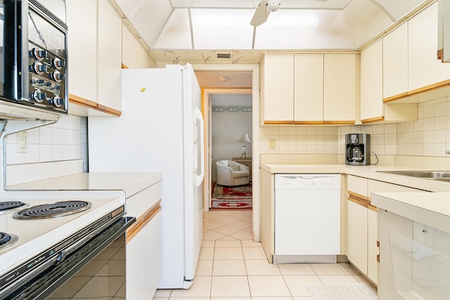 kitchen featuring white appliances, backsplash, sink, light tile floors, and ceiling fan