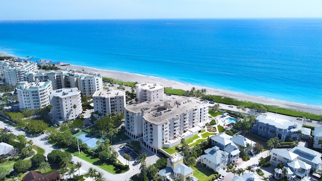 bird's eye view with a water view and a beach view