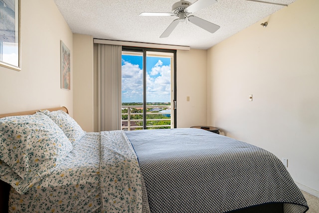 bedroom with access to exterior, ceiling fan, and a textured ceiling