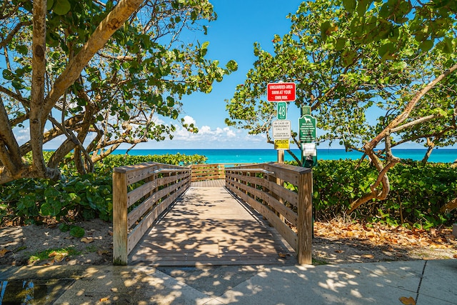 community / neighborhood sign featuring a water view