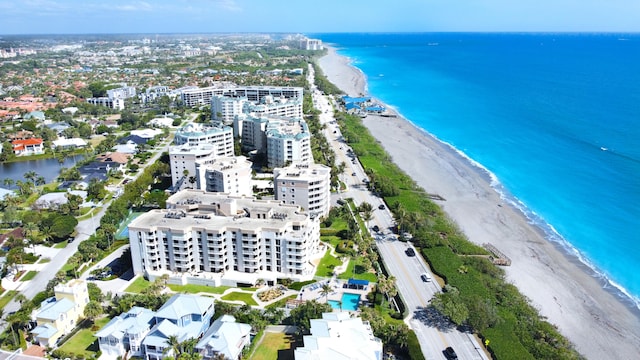 drone / aerial view with a water view and a beach view