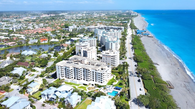 drone / aerial view with a beach view and a water view