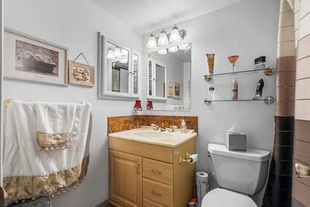 bathroom featuring toilet and large vanity