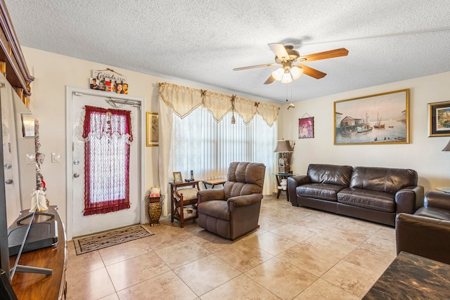 tiled living room featuring a textured ceiling and ceiling fan