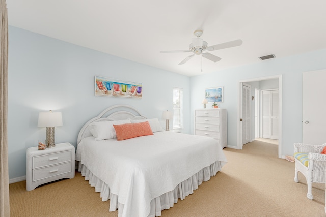 bedroom featuring light carpet and ceiling fan