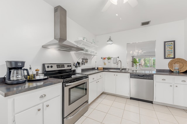 kitchen featuring wall chimney exhaust hood, sink, light tile flooring, ceiling fan with notable chandelier, and stainless steel appliances