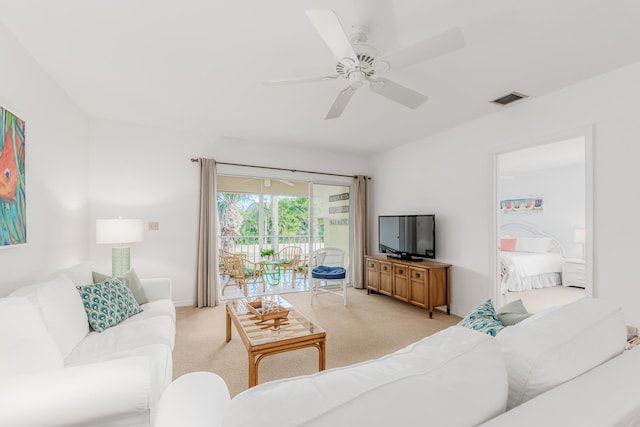 carpeted living room featuring ceiling fan