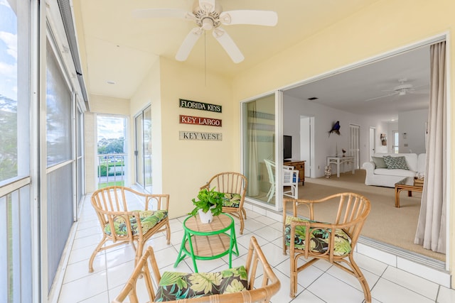 sunroom featuring ceiling fan