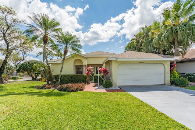 view of front of home with a garage and a front lawn