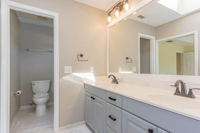 bathroom with tile floors, dual bowl vanity, and toilet