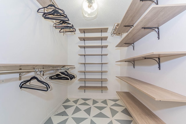 spacious closet featuring tile floors