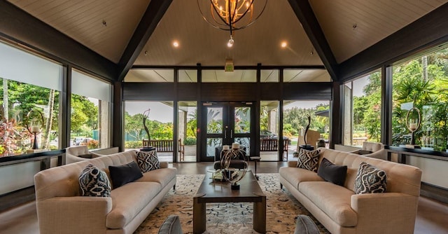 sunroom featuring vaulted ceiling, french doors, a chandelier, and plenty of natural light