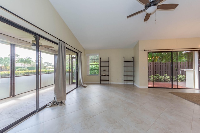 spare room featuring vaulted ceiling, ceiling fan, and light tile flooring