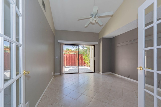 spare room with french doors, ceiling fan, light tile flooring, and lofted ceiling