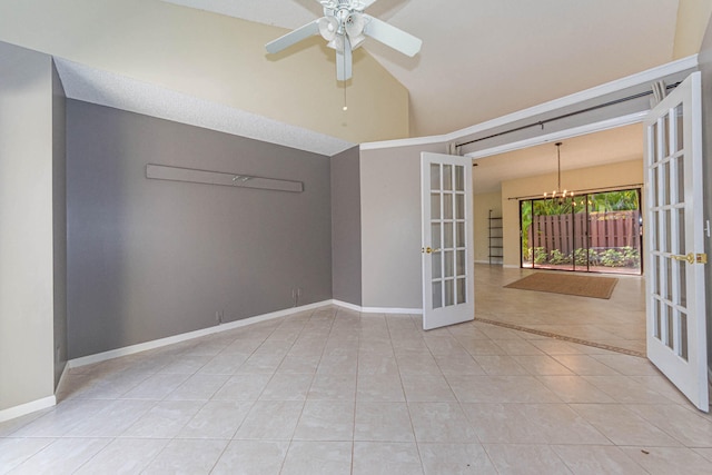 tiled empty room featuring french doors, ceiling fan with notable chandelier, and a high ceiling