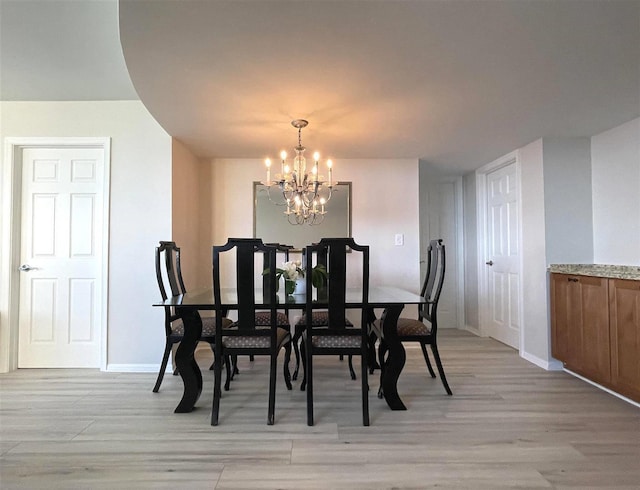 dining room with a chandelier and light wood-type flooring