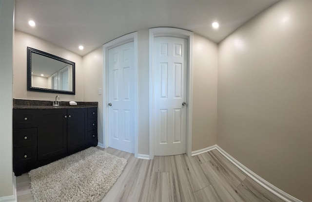 bathroom featuring wood-type flooring and vanity