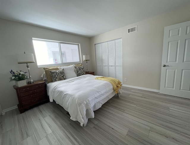 bedroom featuring light hardwood / wood-style flooring and a closet