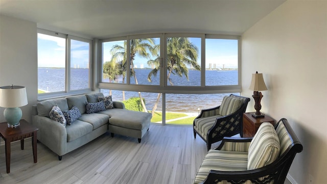 sunroom / solarium featuring a water view