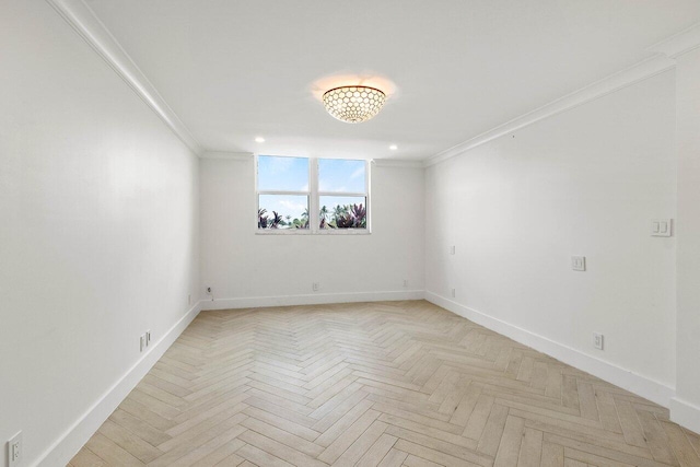 empty room with ornamental molding and light parquet floors