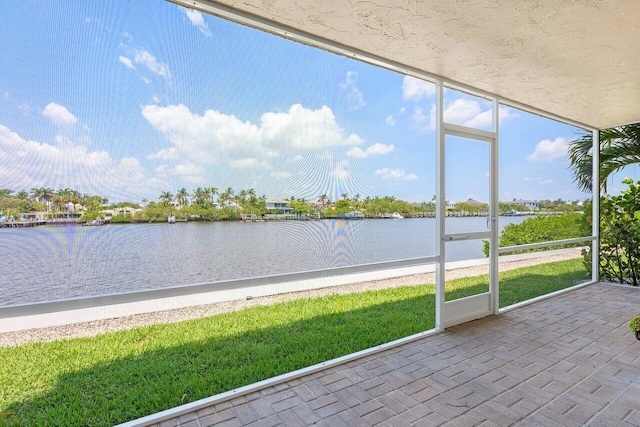 unfurnished sunroom with a water view