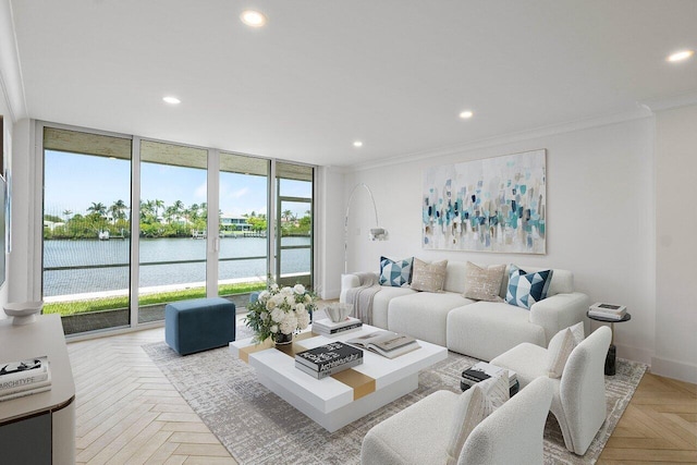 living room with floor to ceiling windows, a wealth of natural light, a water view, and light parquet flooring