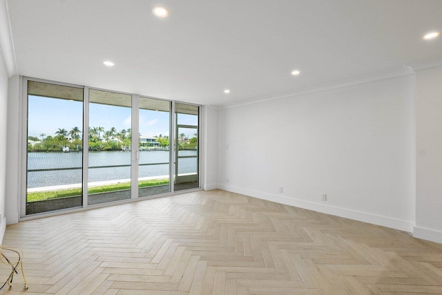 spare room with light parquet floors, a wall of windows, and a wealth of natural light