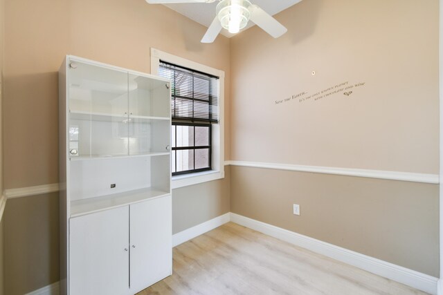 empty room with light wood-type flooring and ceiling fan