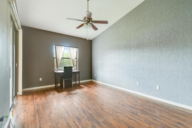 unfurnished office with a textured ceiling, dark hardwood / wood-style floors, ceiling fan, and lofted ceiling