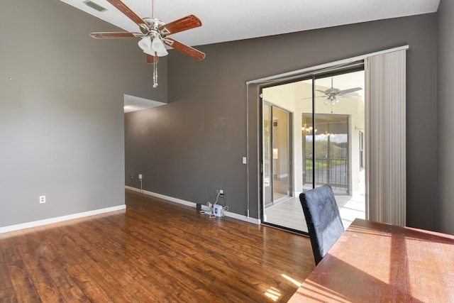 spare room featuring dark hardwood / wood-style floors, ceiling fan, and lofted ceiling