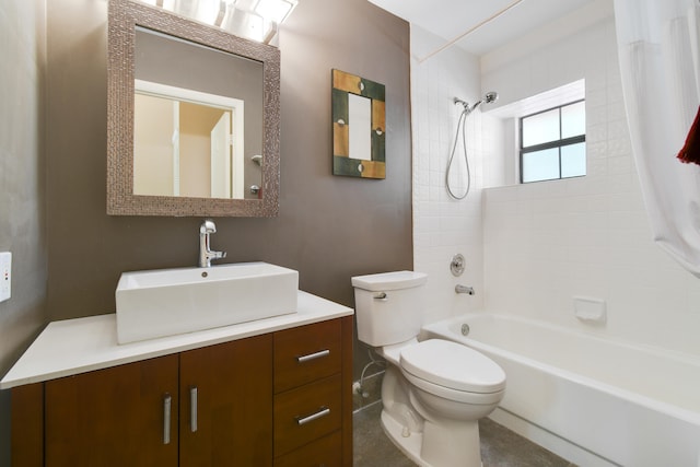 full bathroom featuring vanity, tiled shower / bath combo, and toilet