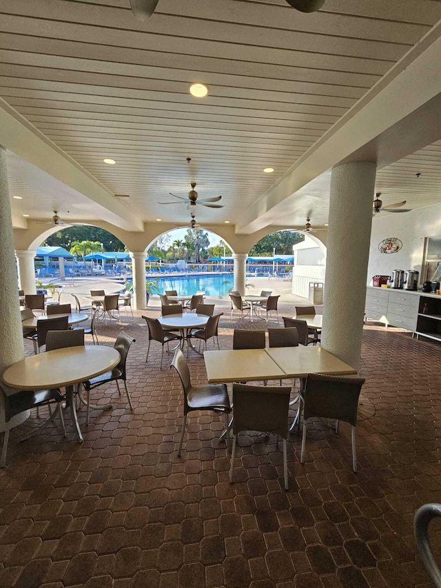 view of patio / terrace featuring ceiling fan and a community pool