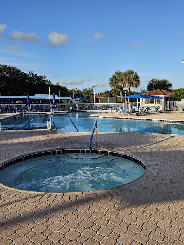 view of pool with a community hot tub