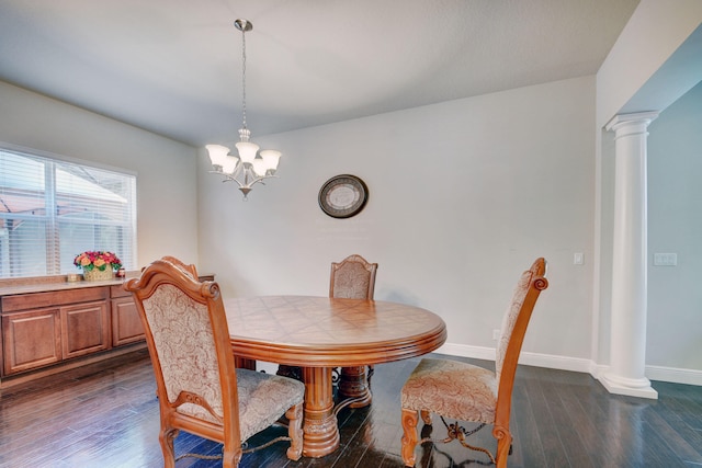 dining space featuring a chandelier, ornate columns, and dark hardwood / wood-style flooring