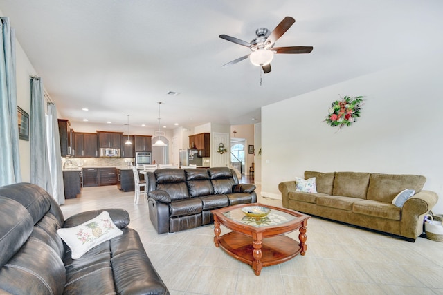 living room with ceiling fan and light tile patterned floors