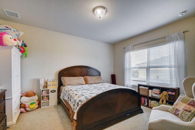 carpeted bedroom featuring a textured ceiling