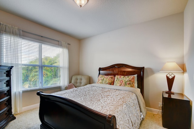 bedroom featuring light colored carpet