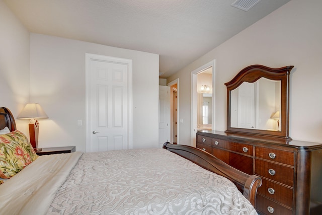 bedroom featuring ensuite bath and a closet