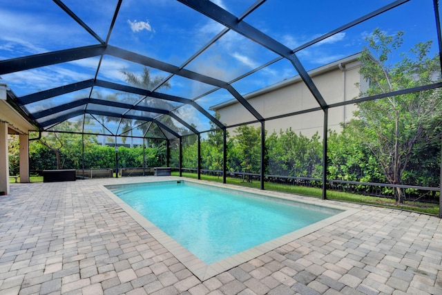 view of swimming pool with a patio and a lanai