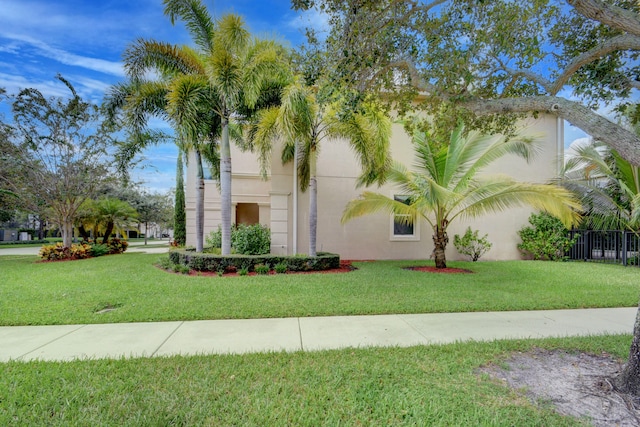 mediterranean / spanish home with a front lawn