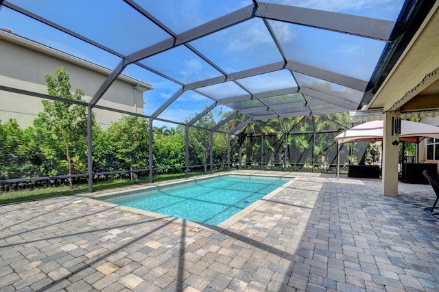 view of pool with a lanai and a patio area