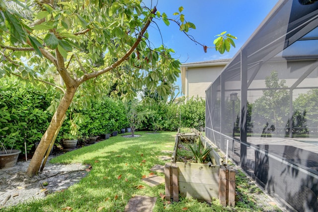 view of yard with glass enclosure