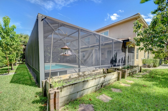 exterior space featuring glass enclosure and a lawn