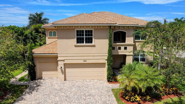 mediterranean / spanish house featuring a garage